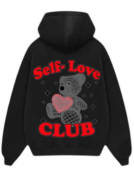 A black pullover hoodie shown from both the front and back. The front is plain, while the back features a graphic of a gray teddy bear holding a pink heart, surrounded by small rhinestone-like dots, with the words 'Self-Love CLUB' in red arched above and below.