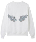 A white crewneck sweatshirt shown from both the front and back views. The front features a small silver wing graphic on the left chest, while the back features a larger, detailed silver wing graphic with a glittery texture.