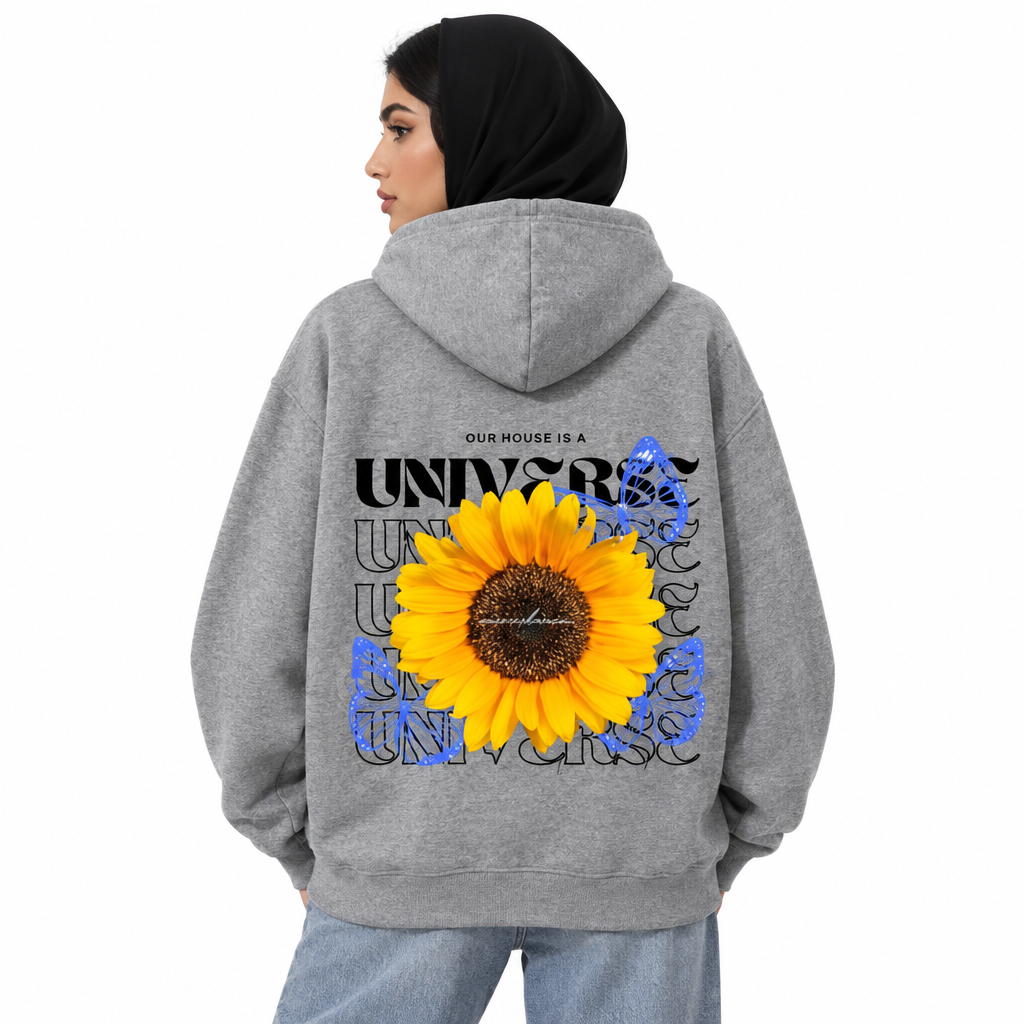 Female model in grey sunflower UNIVERSE hoodie, back view studio shot