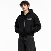 Male model wearing the black SAVAGE zip-up jacket in a white studio